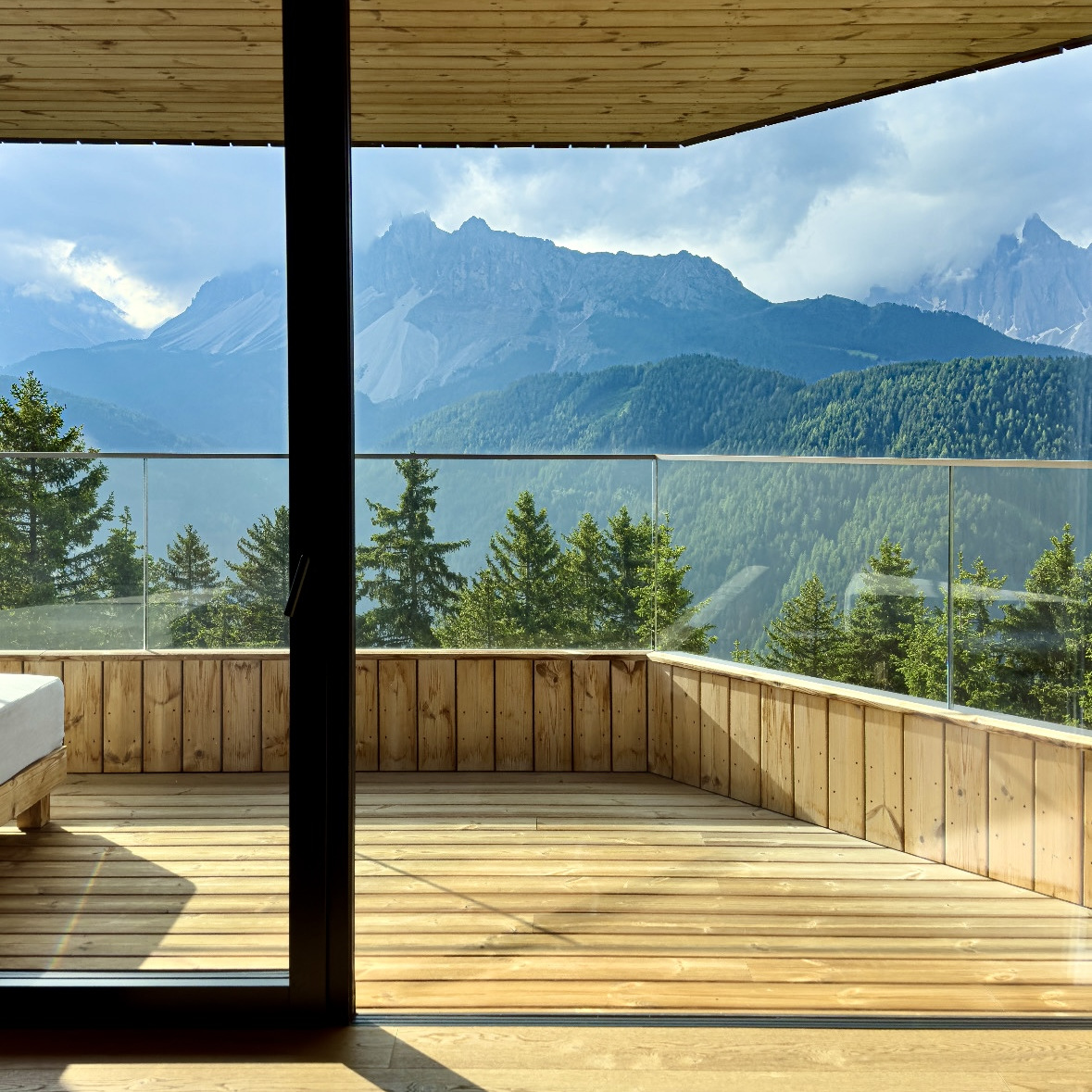 Timber guest suite opening onto a mountain terrace in a design led tourism property